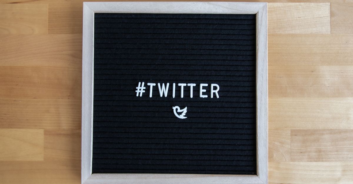Black letter board with #Twitter hashtag and bird icon, ideal for social media themes.